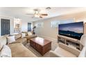 Spacious living room featuring plush carpeting, a large sofa, and a mounted television at 5505 Reiter Ave, Las Vegas, NV 89108