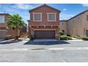 Charming townhome features stucco siding, a well-maintained yard, and a two-car garage at 715 Taliput Palm Pl, Henderson, NV 89011