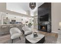 Open-concept living space with a fireplace, a breakfast bar, and a view to the dining room at 7221 W Washington Ave, Las Vegas, NV 89128