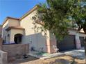 Side view of a two-story house featuring a private entrance, and desert landscaping at 728 Twilight Blue Ave, North Las Vegas, NV 89032