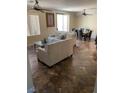 Bright living room with neutral toned sofa and tiled floors, perfect for entertaining or relaxing at 728 Twilight Blue Ave, North Las Vegas, NV 89032
