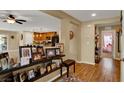 Open-concept entryway with decorative shelving, hardwood floors, and views into the kitchen and other living spaces at 759 Star Apple Ln, Las Vegas, NV 89178