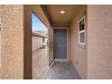 Inviting covered front porch with brick pavers and a stylish front door, offering a warm welcome to the home at 759 Star Apple Ln, Las Vegas, NV 89178