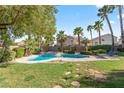 Inviting pool and spa surrounded by lush landscaping, palms, and a lounge area at 8121 Eagle Clan Ct, Las Vegas, NV 89131