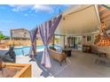 Inviting covered patio with comfortable seating, perfect for outdoor gatherings and relaxation at 8700 Isola Dr, Las Vegas, NV 89117