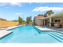 Beautiful in-ground pool with steps and baja shelf for sunbathing and enjoying the outdoors at 8700 Isola Dr, Las Vegas, NV 89117
