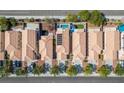 Birds eye view of homes featuring red-tile roofs, a community pool, and well-maintained landscaping at 8884 Perfect Diamond Ct, Las Vegas, NV 89129