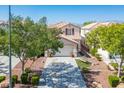 Inviting two-story home with mature trees, desert landscaping, and a spacious two-car garage at 8884 Perfect Diamond Ct, Las Vegas, NV 89129