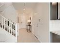 Bright foyer with white walls, tiled floor, stairs, and a console table at 9588 Archer Peak Ct, Las Vegas, NV 89143
