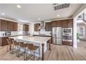 Spacious kitchen with large island, stainless steel appliances, and dark wood cabinets at 9655 Skye Star Ave, Las Vegas, NV 89166