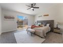 Cozy bedroom featuring a king-size bed, soft carpet, and a sliding door to the backyard at 9705 Standard Ave, Las Vegas, NV 89129