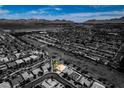 A neighborhood view of the property outlined in green with mountains in the background at 1017 Guided Dancer Ave, Henderson, NV 89015