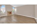 Spacious living room featuring a cozy fireplace, large windows and new floors at 104 Hutton Ln, Las Vegas, NV 89145