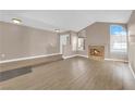 Open living room featuring a cozy fireplace, large windows and new floors at 104 Hutton Ln, Las Vegas, NV 89145