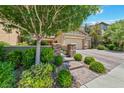 Beautiful home featuring a brick driveway, lush landscaping, and a secure gated entrance at 1134 Pandora Canyon St, Henderson, NV 89052