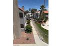 Attractive condo community featuring lush landscaping, serene walkways, and a refreshing pool area at 2212 Sunfish Dr # D, Henderson, NV 89014