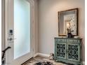 Cozy home entryway with frosted glass door, wood floors, and decorative accents at 2507 Silent View Ave, Henderson, NV 89044