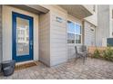 Inviting front entrance with stylish blue door and cozy outdoor seating area at 2507 Silent View Ave, Henderson, NV 89044