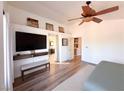 Serene bedroom featuring a ceiling fan, wood-look floors, and ample natural light at 2549 Sundew Ave, Henderson, NV 89052