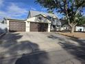 Attractive two-story home with a three-car garage, mature landscaping, and a well-maintained driveway at 3056 Garnet Ct, Las Vegas, NV 89121