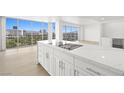 Modern kitchen island with stainless steel appliances, white cabinets, and stunning city views at 3111 Bel Air Dr # 24G, Las Vegas, NV 89109