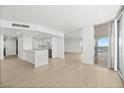 Bright living room features an open floor plan with wood floors, modern lighting, and city views at 3111 Bel Air Dr # 24G, Las Vegas, NV 89109