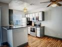 Modern kitchen with stainless steel appliances and a breakfast bar at 3150 Soft Breezes Dr # 1033, Las Vegas, NV 89128