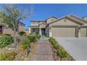 Charming two-story home featuring a three-car garage, neutral paint scheme and rock landscaping at 3632 Red Fir St, Las Vegas, NV 89135