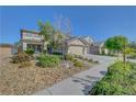 Charming two-story home featuring a three-car garage, neutral paint scheme and rock landscaping at 3632 Red Fir St, Las Vegas, NV 89135