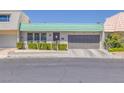 Charming single-story home featuring a green tile roof and well-manicured front yard landscaping at 3815 Atlantis St, Las Vegas, NV 89121