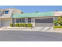 Charming single-story home featuring a green tile roof and well-manicured front yard landscaping at 3815 Atlantis St, Las Vegas, NV 89121