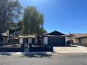 Lovely single-story home with desert landscaping, a paved driveway, and secure fenced yard at 3920 Aspencrest Dr, Las Vegas, NV 89108