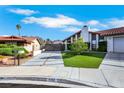View of the home featuring a modern driveway, red tile roof, and desert landscaping at 4143 Chela Cir, Las Vegas, NV 89120