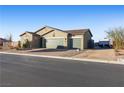 Lovely one-story home with a three car garage, desert landscaping, and space for RV parking at 42 Late Harvest Ave, Pahrump, NV 89060