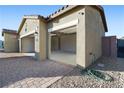 Spacious three-car garage with ample storage, a paver driveway and an open door at 42 Late Harvest Ave, Pahrump, NV 89060