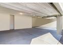 Bright and spacious three-car garage featuring freshly painted walls and a clean, concrete floor at 42 Late Harvest Ave, Pahrump, NV 89060