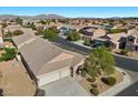 An aerial view of a single-story home featuring a three-car garage and desert landscaping at 4308 Brazil Palm Ct, North Las Vegas, NV 89032