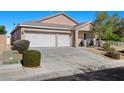 Charming single-story home featuring a three-car garage and desert landscaping at 4308 Brazil Palm Ct, North Las Vegas, NV 89032