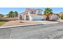 A two-story home features low maintenance landscaping, a tile roof and a two-car garage at 459 Kelsford Dr, Las Vegas, NV 89123