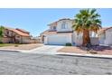 A two-story home features low maintenance landscaping, a tile roof and a two-car garage at 459 Kelsford Dr, Las Vegas, NV 89123