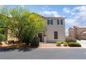 Two-story home with a neutral stucco exterior, shutters, and mature landscaping at 4610 Lime Straight Dr, Las Vegas, NV 89115