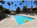 Serene community pool features clear blue water and a playful yellow inflatable toy at 5260 Mission Monterey Ln # 208, Las Vegas, NV 89107