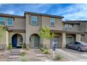 Charming townhouse with a covered entry, desert landscaping, and a brick paved driveway at 5299 Silver Branch Ave, Las Vegas, NV 89118