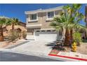Two story tan home with desert landscaping and palm trees at 576 Foster Springs Rd, Las Vegas, NV 89148