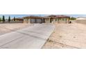 A single-story home with a spacious driveway, neutral color scheme, and an attached garage at 6131 Rio Vista St, Las Vegas, NV 89130