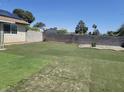 Spacious backyard with artificial turf and a concrete perimeter block wall, providing privacy at 6231 Santa Maria Ave, Las Vegas, NV 89108