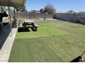 Large backyard featuring artificial turf sections, picnic table, and perimeter wall at 6231 Santa Maria Ave, Las Vegas, NV 89108
