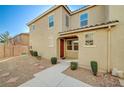 Welcoming two-story home featuring desert landscaping and a tiled roof under a clear blue sky at 6255 W Arby Ave # 258, Las Vegas, NV 89118