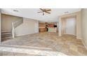 Open-concept living space features tile flooring, staircase, and a seamless flow to the kitchen at 6255 W Arby Ave # 258, Las Vegas, NV 89118