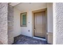 Inviting front entrance with a stylish stone accent wall and a neutral-toned door, offering a welcoming first impression at 6288 Dolosonte St, Las Vegas, NV 89113